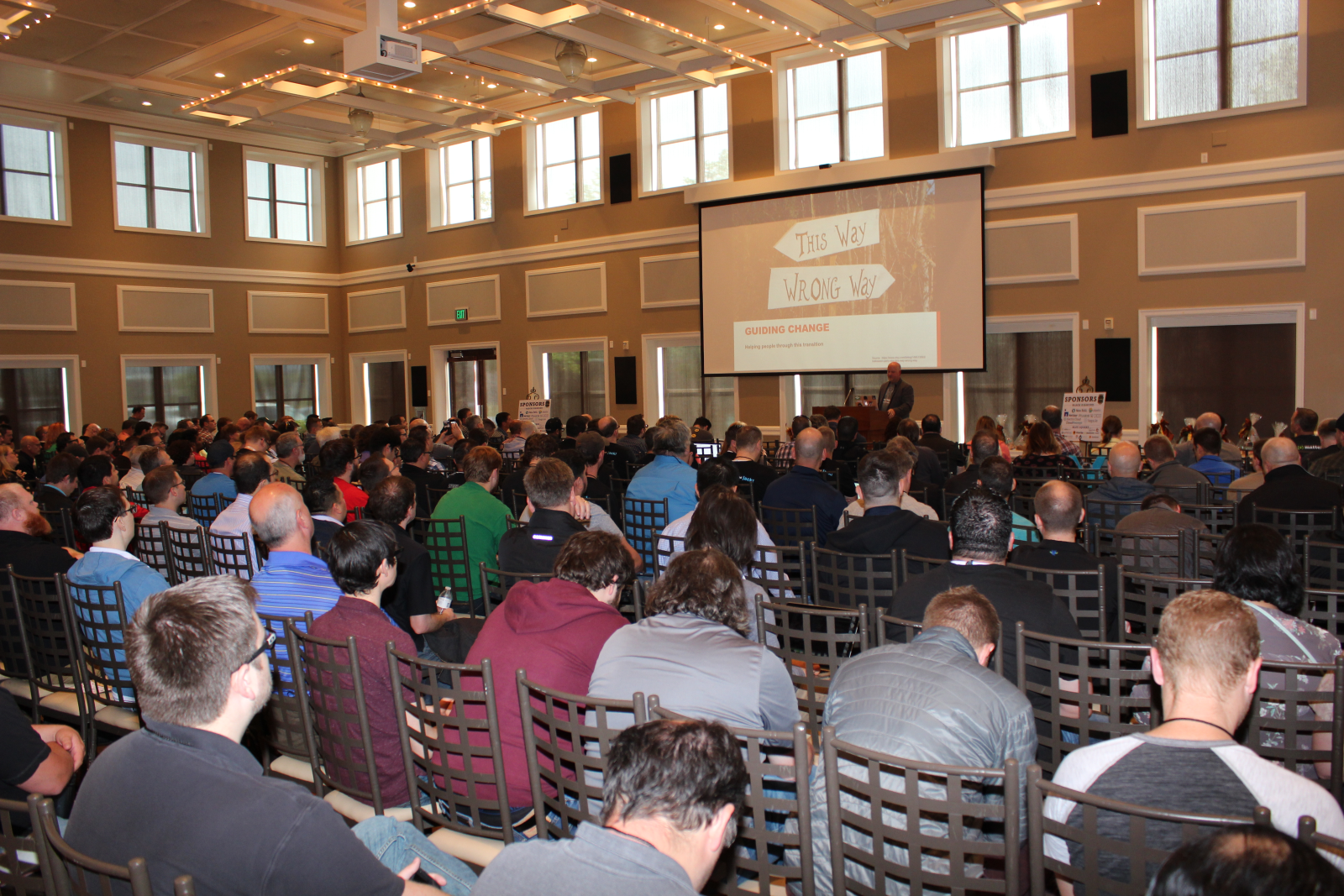 A packed hall at Salt Lake City DevOps Days, with a speaker at the podium